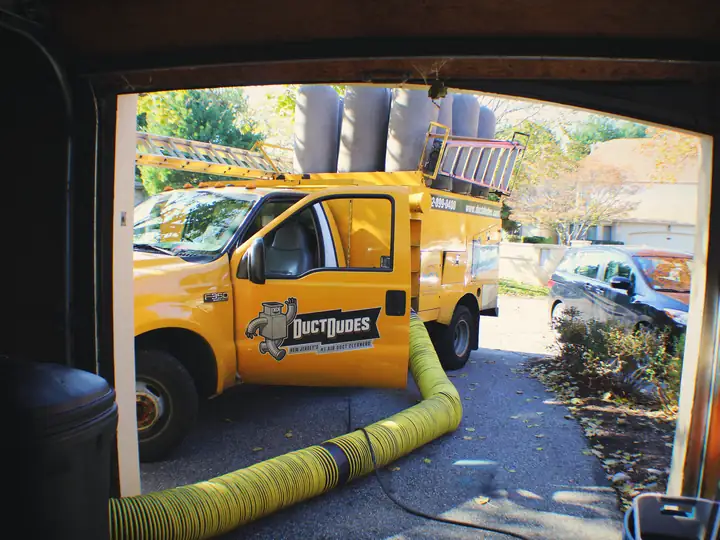 Duct Dudes truck with 16,000 CFM hose running to a New Jersey home